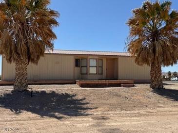 Single-story home with palm trees and desert landscaping at 675 Stevens Ave, Overton, NV 89040