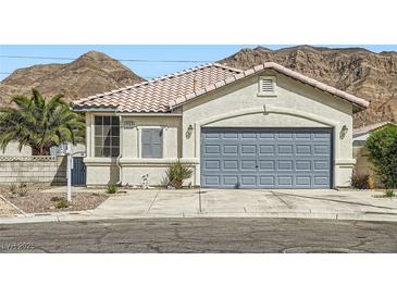 Inviting single-story home with a two-car garage and desert landscaping at 1252 N Sloan Ln, Las Vegas, NV 89110
