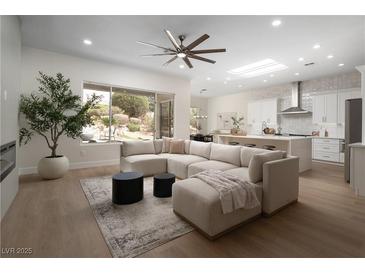 Bright, open-concept living room featuring hardwood floors, a neutral palette, and modern furnishings at 1624 Preston Park Dr, Henderson, NV 89052