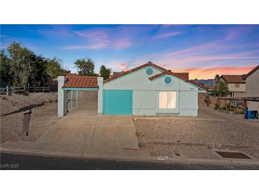 Charming single-story home featuring a tile roof, covered parking, and desert landscaping at 1775 Esteban Ave, Laughlin, NV 89029