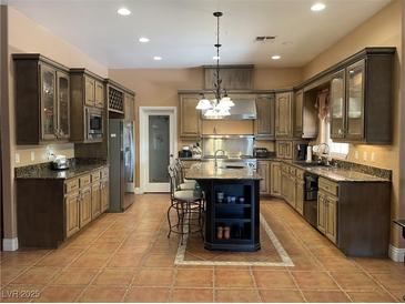 Spacious kitchen featuring an island with granite countertops and stainless steel appliances at 210 Lailani St, Las Vegas, NV 89110