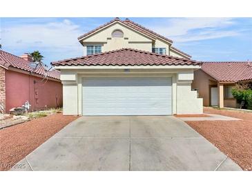 Home with a two car garage, red tiled roof, desert rock landscaping, and concrete driveway at 3444 Trilogy Dr, Las Vegas, NV 89108