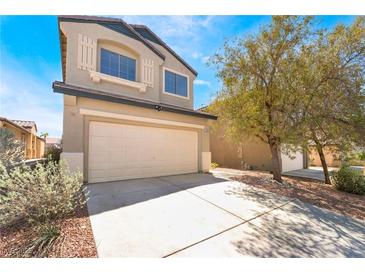 Two-story home featuring shuttered windows, desert landscaping and a two car garage at 6405 Strongbow Dr, Las Vegas, NV 89156