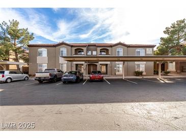 Condominium building with covered parking spots and appealing tan exterior paint and trim at 9000 Las Vegas Blvd # 2243, Las Vegas, NV 89123