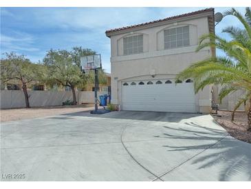 Two-story home with a large driveway and basketball hoop, great for outdoor fun at 9509 Arrowhead Falls Ct, Las Vegas, NV 89148