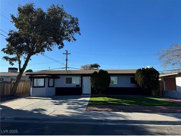 Charming single-story home with well-maintained front yard and mature tree on a sunny day at 2820 Richfield Blvd, Las Vegas, NV 89102