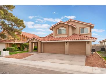 Charming two-story home with a three-car garage, red tile roof, and well-maintained landscaping at 2908 Reef Bay Ln, Las Vegas, NV 89128