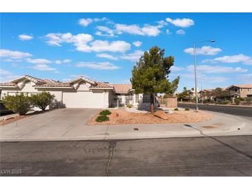 Charming single-story home featuring a two-car garage, desert landscaping, and a tile roof at 3517 S Dapple Gray Rd, Las Vegas, NV 89147