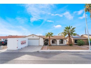 Charming single-story home featuring a two car garage and desert landscaping with mature palms at 3661 Margarita Way, Las Vegas, NV 89103