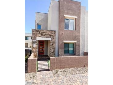 Modern two-story home with stone accents and a charming gated front yard at 600 N Carriage Hill Dr # 1019, Las Vegas, NV 89138