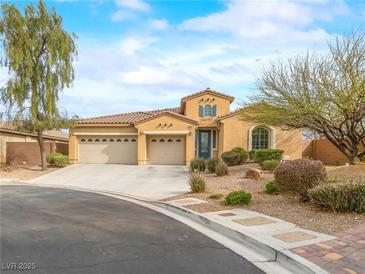 Charming one-story home with a well-manicured lawn, three-car garage, and beautiful desert landscaping at 6982 Mirkwood Ave, Las Vegas, NV 89178