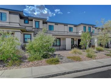 Beautiful townhome featuring desert landscaping, a well-maintained facade, and stone accents in a desirable community at 757 Omaggio Pl, Henderson, NV 89011