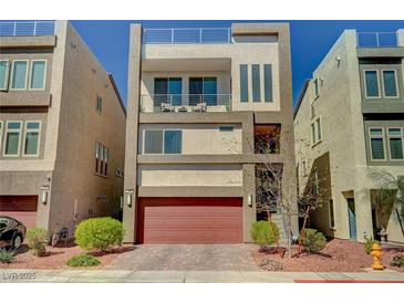 Modern three-story home boasting a roof deck, balcony, two-car garage, and desert landscaping at 7953 Mountain Lilac St, Las Vegas, NV 89113