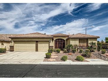 Charming single-story home with a two-car garage, desert landscaping, and an inviting entryway gate at 8698 Waterford Bend St, Las Vegas, NV 89123