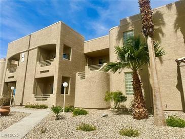 Attractive condo exterior with balconies, mature landscaping, and tan stucco finish at 2232 Aspen Mirror Dr # 203, Laughlin, NV 89029
