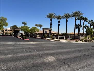 View of the Avalon community entrance with palm trees and desert landscaping on a clear day at 2900 Sunridge Heights Pkwy # 816, Henderson, NV 89052