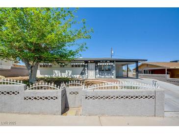 Charming single-story home featuring stone accents, a covered carport, and a well-maintained front yard at 304 Elliott Ave, Las Vegas, NV 89106