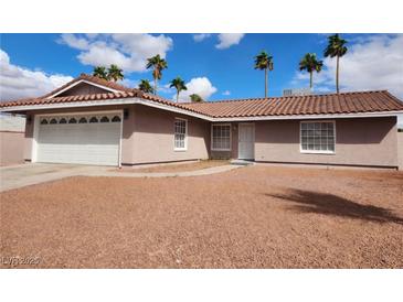 Charming single-story home with a two-car garage and well-maintained front yard and attractive desert landscaping at 4128 Annie Oakley Dr, Las Vegas, NV 89121