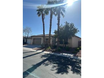 Charming single-story home with desert landscaping and mature palm trees at 6475 Benbrook Springs Dr, Las Vegas, NV 89131