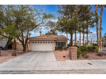 Charming single-story home featuring a tile roof, two-car garage, and mature landscaping at 6654 Coronado Crest Ave, Las Vegas, NV 89139