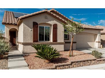 Charming single-story home features desert landscaping, tiled roof, and solar panels for energy efficiency at 7386 Campbell Ranch Ave, Las Vegas, NV 89179