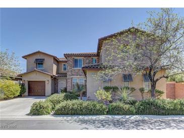 Stunning two-story home with a combination of stone and stucco, plus a well-manicured yard at 9992 Sky Parlor Rd, Las Vegas, NV 89178