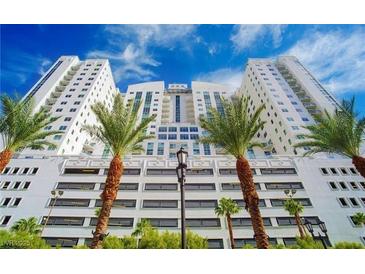 Stunning high-rise exterior with a white facade, palm trees, and blue sky creating a modern aesthetic at 150 N Las Vegas Blvd # 818, Las Vegas, NV 89101