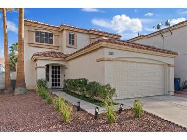 Charming two-story home with a two car garage, desert landscaping, and a terracotta tile roof at 1677 Balsam Mist Ave, Las Vegas, NV 89183