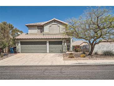 Charming two-story home featuring a well-manicured lawn, tiled roof and two-car garage at 2288 Red Alder St, Henderson, NV 89002