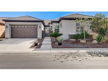 Charming single story home showcasing a two car garage, and attractive desert landscaping at 4137 Cackling Goose Dr, North Las Vegas, NV 89084