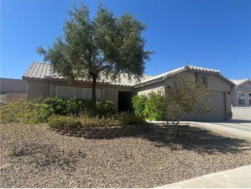 Charming single-story home with well-maintained desert landscaping and mature trees in front yard at 511 Credence Ave, Henderson, NV 89002