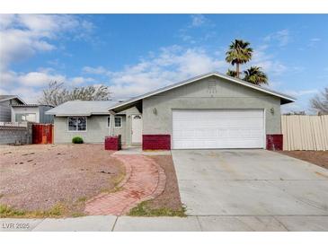 Charming single-story home with a well-maintained front yard and attached two-car garage at 5620 Pinecone Pl, Las Vegas, NV 89108