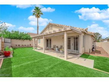 Outdoor living with covered patio, lush green lawn, and plenty of space to relax or entertain at 8009 Tailwind Ave, Las Vegas, NV 89131