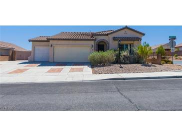 Charming single-story home with a three-car garage, desert landscaping, and a tile roof at 8249 Jo Marcy Dr, Las Vegas, NV 89131