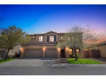 Charming two-story home with a well-manicured lawn and a three-car garage at 8537 Eureka Heights Ct, Las Vegas, NV 89178