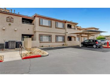 View of the exterior with covered parking at this multi-Gathering residence with desert landscaping at 8725 W Flamingo Rd # 240, Las Vegas, NV 89147