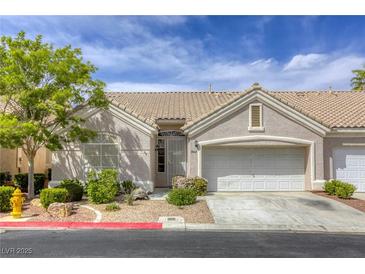 Charming single-story home features a tile roof, two-car garage, and well-maintained landscaping at 9664 Emeraude Ave, Las Vegas, NV 89147