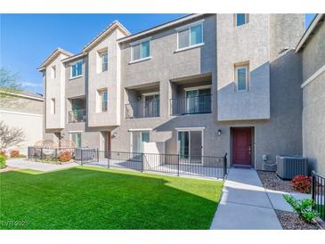 Modern townhouse with a well-maintained lawn and inviting outdoor spaces at 2843 Kona Blue Ln # 4, Las Vegas, NV 89183