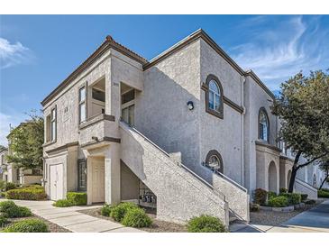 Charming two-story condo building showcasing stucco, private entrances, and well-maintained landscaping at 3125 N Buffalo Dr # 1133, Las Vegas, NV 89128