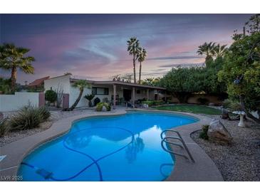 Inviting pool with lush backyard, perfect for relaxing and entertaining under the sunset at 3200 Bryant Ave, Las Vegas, NV 89102