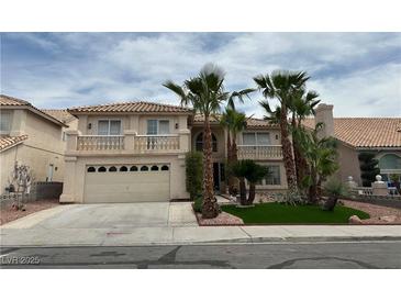 Two-story home with desert landscaping, balcony, and attached two-car garage at 3340 Shallow Pond Dr, Las Vegas, NV 89117