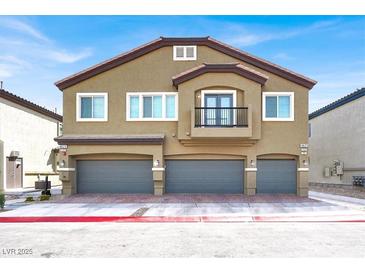 Two story townhome featuring a private balcony and three garages at 4625 Ridgeley Ave # 102, North Las Vegas, NV 89084