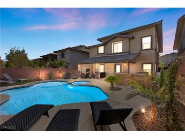 Inviting backyard oasis featuring a pool, spa, and outdoor seating, perfect for entertaining in a luxury home at 5594 Trilling Bird Dr, Las Vegas, NV 89135