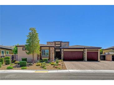 Charming single-story home boasting a three-car garage, stone accents, and meticulously landscaped front yard at 7095 Falabella Ridge Ave, Las Vegas, NV 89131