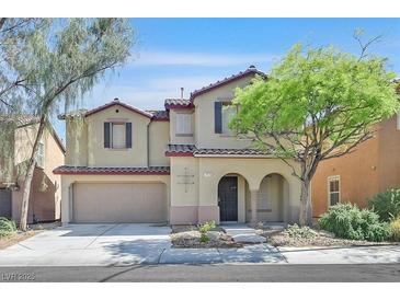 Charming two-story home featuring a stucco exterior, attached garage, and well-manicured landscaping at 7173 Las Colinas Ave, Las Vegas, NV 89179