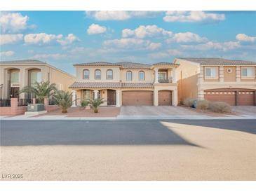 Beautiful two-story home with a three-car garage, front yard landscaping and a second story covered patio at 8543 Alpine Vineyards Ct, Las Vegas, NV 89139