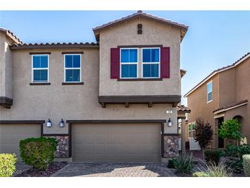 Charming two-story townhome featuring a two-car garage and stone accents at 105 Pollentia Ave, North Las Vegas, NV 89084
