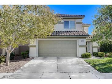 Charming two-story home with a well-maintained front yard and a spacious two car garage at 1348 Calle Montery St, Las Vegas, NV 89117