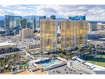 Stunning aerial view of a luxury high-rise with a pool and Las Vegas skyline at 145 E Harmon Ave # 3103, Las Vegas, NV 89109