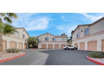 Lovely condominium complex featuring attached garages and neatly maintained landscaping at 1830 N Buffalo Dr # 2043, Las Vegas, NV 89128